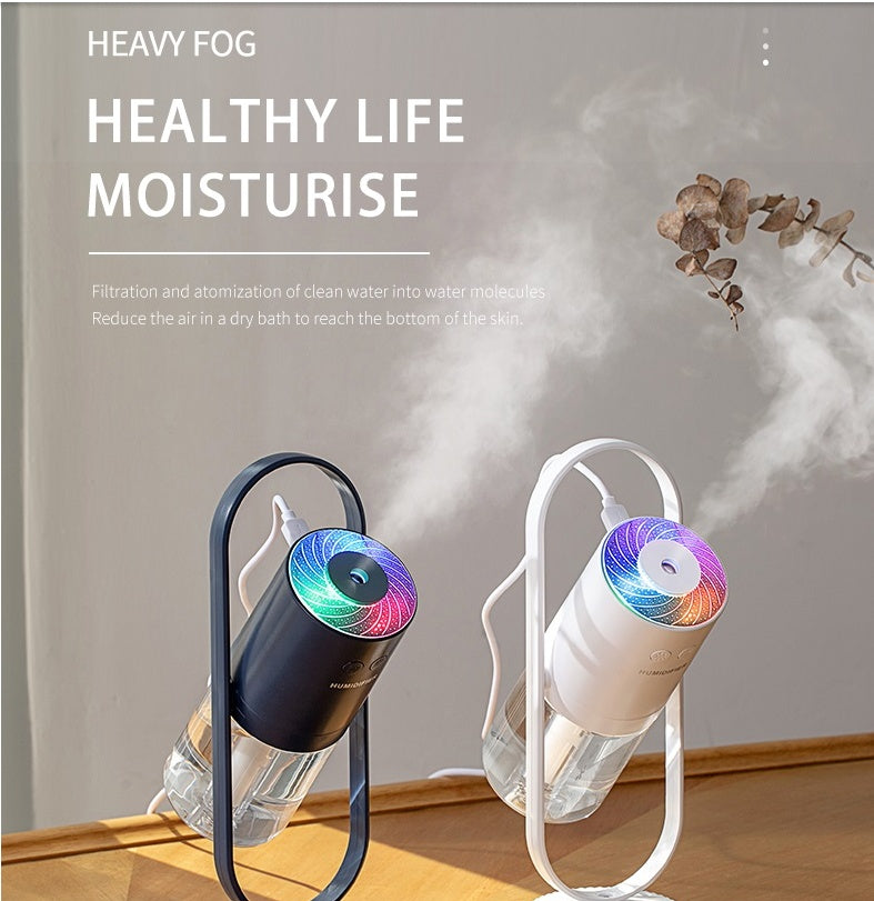 Aurora humidifier in pink, angled in its stand